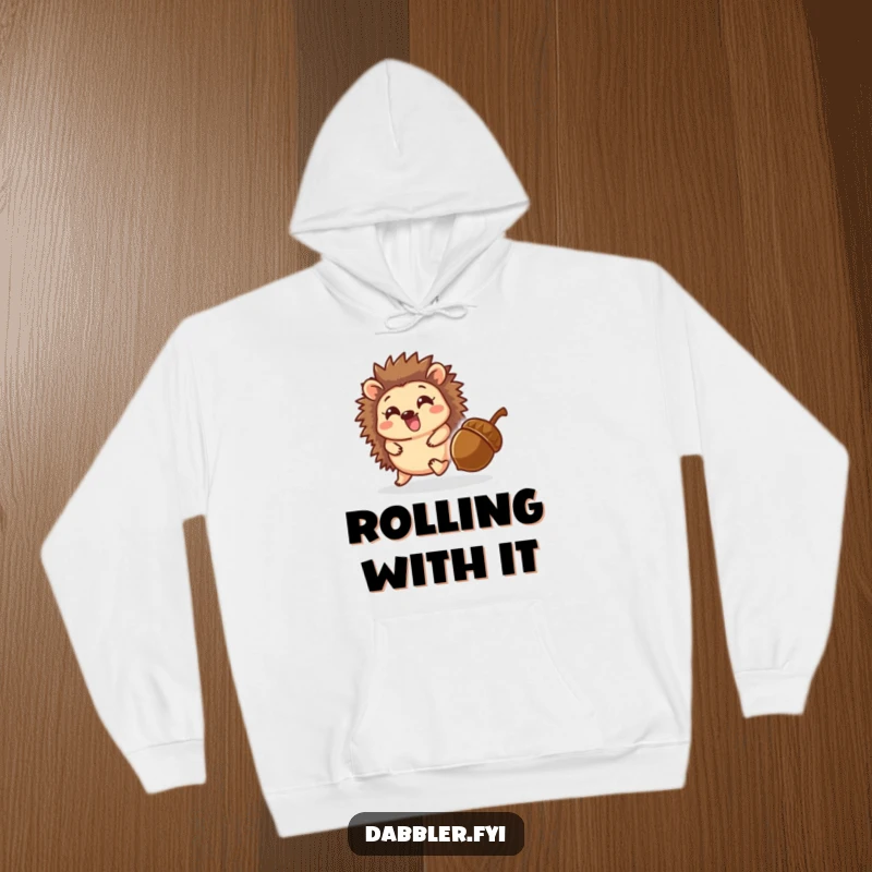 Funny hoodie displaying a delighted hedgehog character playfully chasing a rolling acorn, ideal for comfortable, cheerful wear.