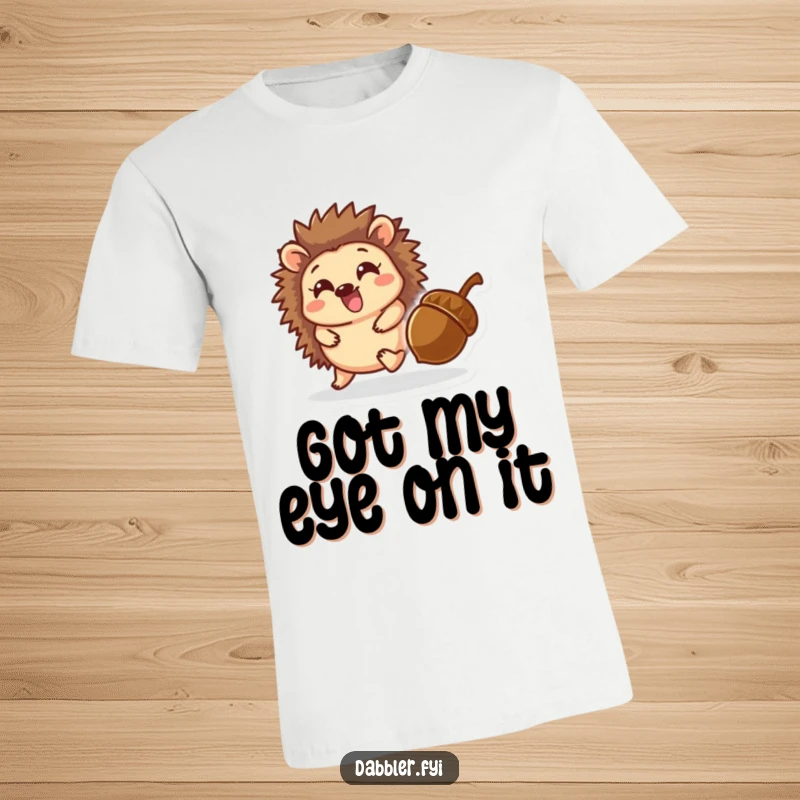 Funny t-shirt featuring a delighted hedgehog character joyfully chasing a rolling acorn through a whimsical, autumnal background.